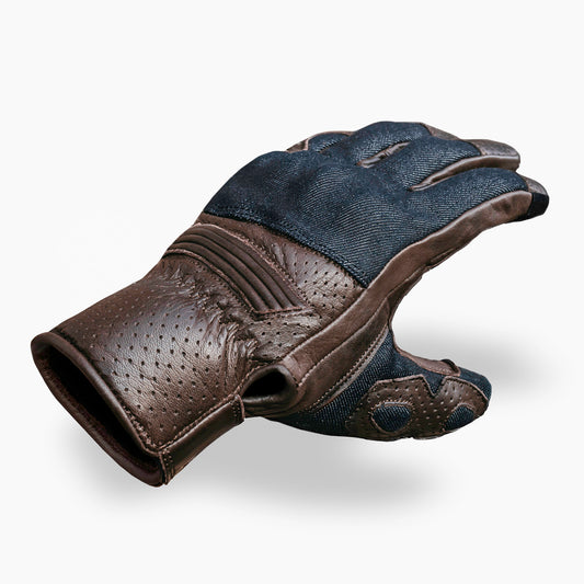 Brown leather and blue denim motorcycle glove with perforated design on a white background