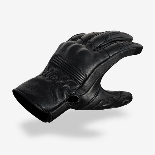 Black leather glove on a white background