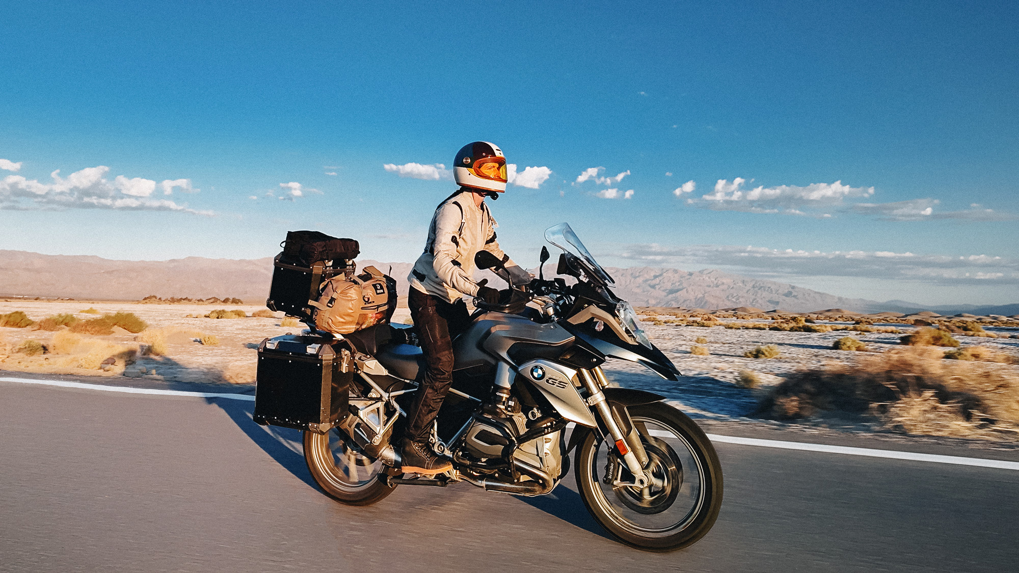 Female motorcyclist riding a fully loaded BMW GS through the desert during a two-week motorcycle trip across the Mountain West.