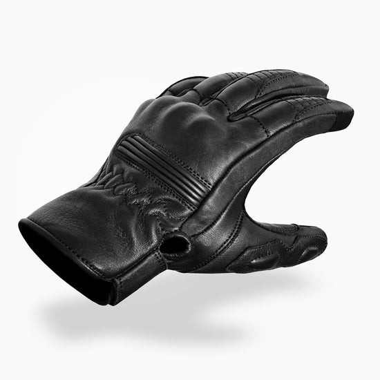 Black leather glove on a white background